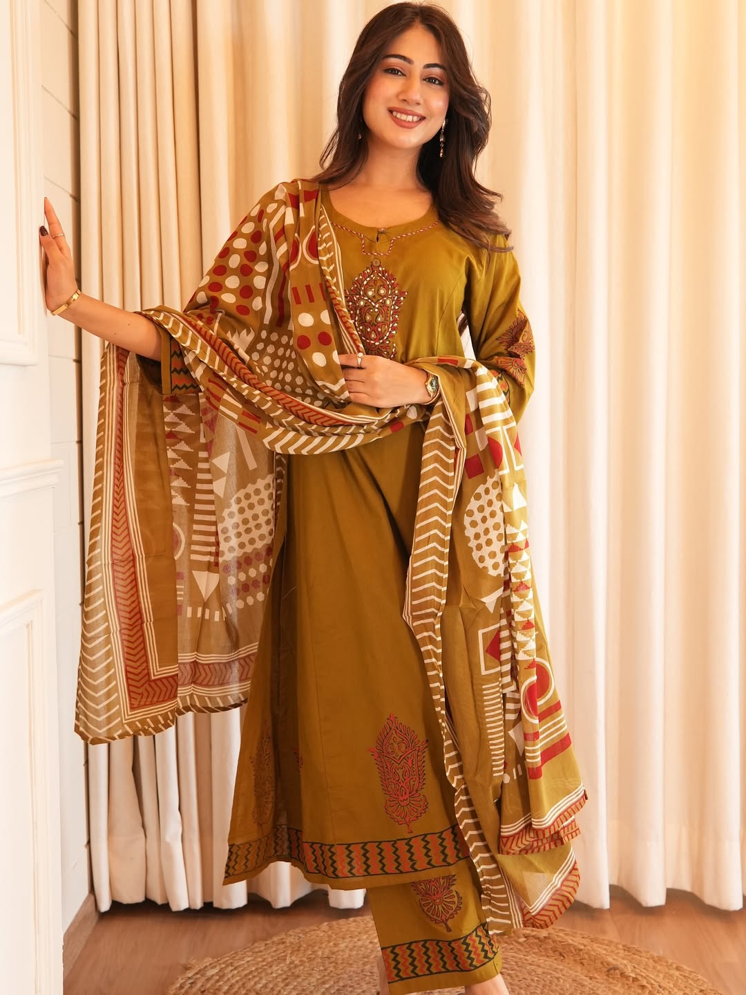 Suit in A Line pattern with hand work details on kurti available in two colors rust red and mustard yellow color