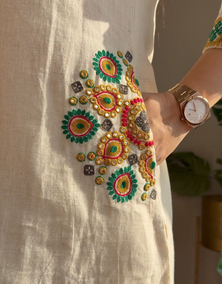 Cotton flex kurti pant set in white colour  with front and back side embroidery and pocket detailing in kurti